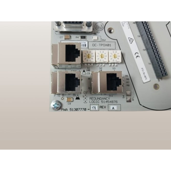 Close-up of Honeywell CC-TPOX01 process control card with connectors and part number visible.